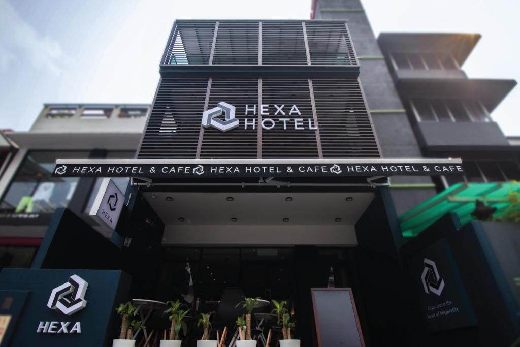 a building with a sign that reads heza hotel at Hexa Hotel & Backpackers Capsules Bukit Bintang in Kuala Lumpur