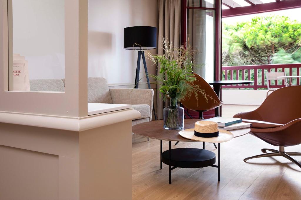 a living room with a table with a hat on it at Villa du Pyla in Pyla-sur-Mer