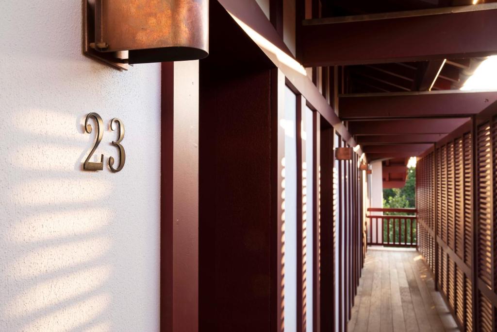 a hallway of a building with a number thirteen on it at Villa du Pyla in Pyla-sur-Mer
