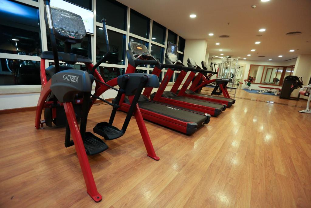 a gym with a row of tread machines in a room at Tolip El Narges in Cairo
