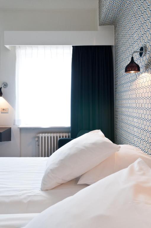 Postel nebo postele na pokoji v ubytování Hotel Queen Anne