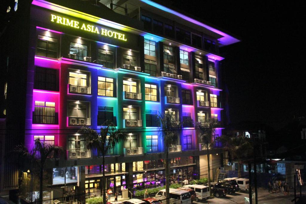 a building with purple and blue lights on it at Prime Asia Hotel in Angeles