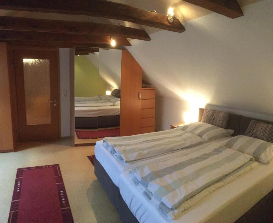 a bedroom with a large bed and a mirror at Ferienwohnung Wilde - Holzkamp in Itzehoe