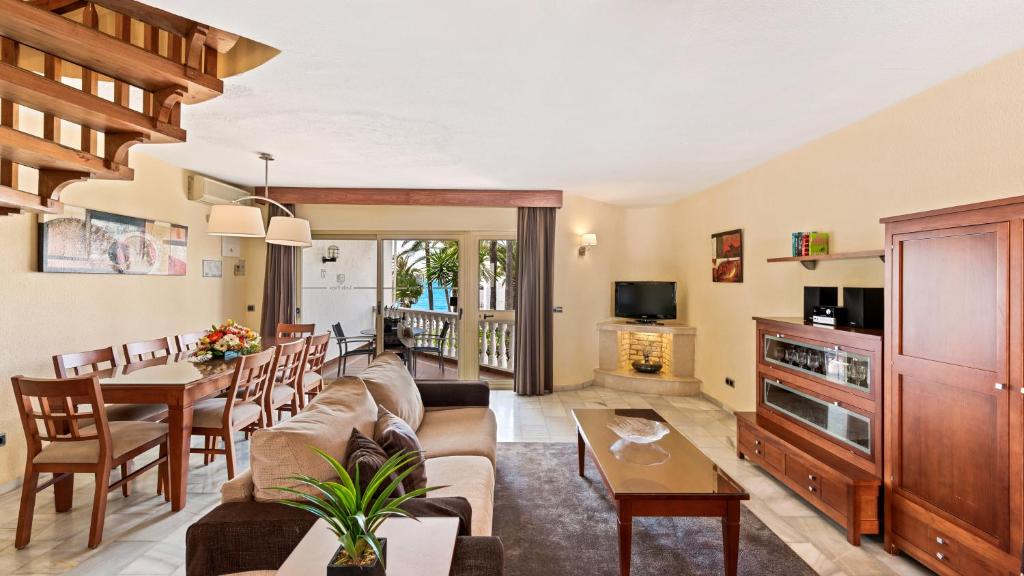 a living room with a couch and a table at Macdonald Leila Playa Resort in La Cala de Mijas