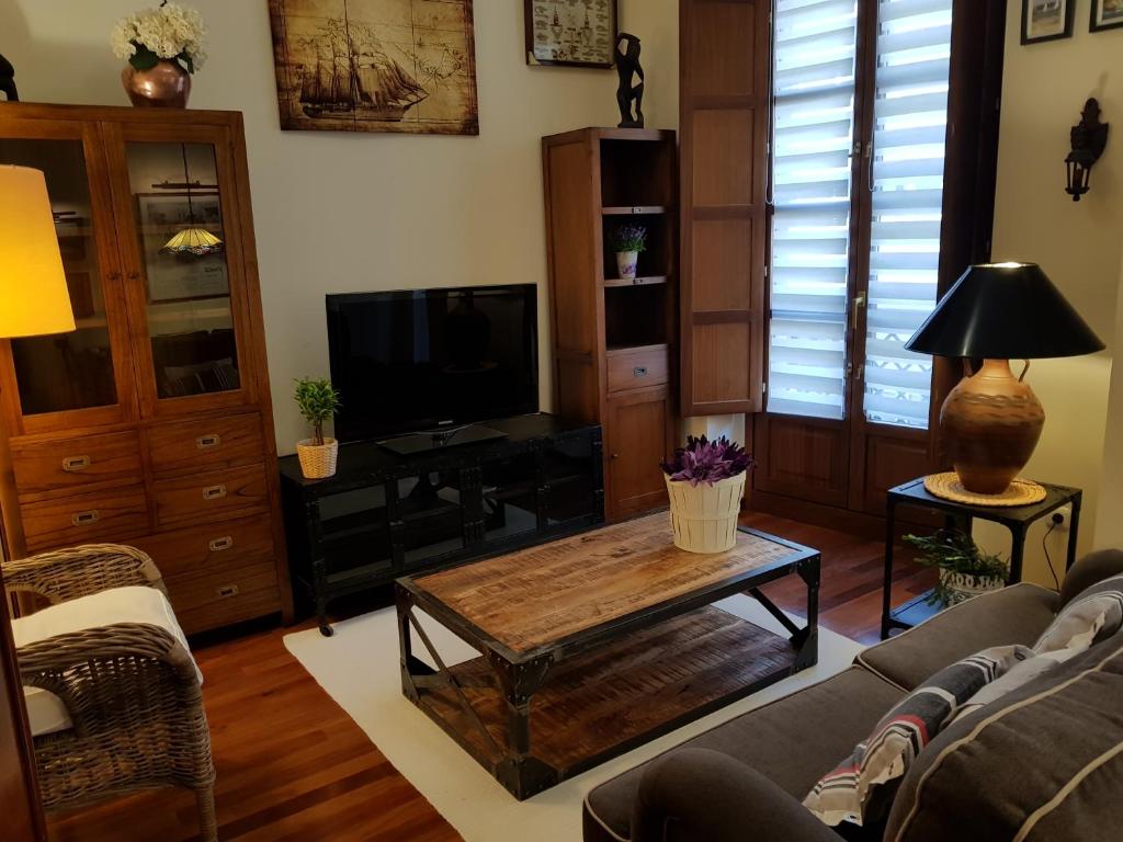 a living room with a couch and a coffee table at PISO DE CALIDAD EN EL CENTRO DEL CENTRO DE GIJON in Gijón