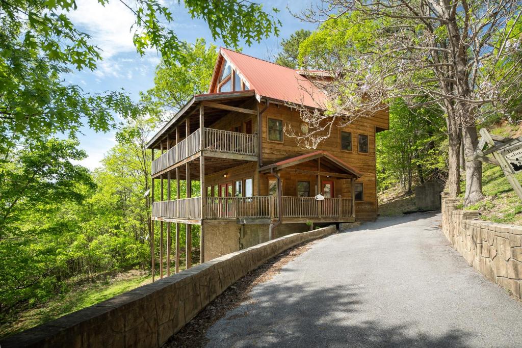 a large wooden house with a walk way to it at Mountain Tyme, Hot Tub, Pool Table, Game Room, 685 FREE tickets each paid day! in Sevierville