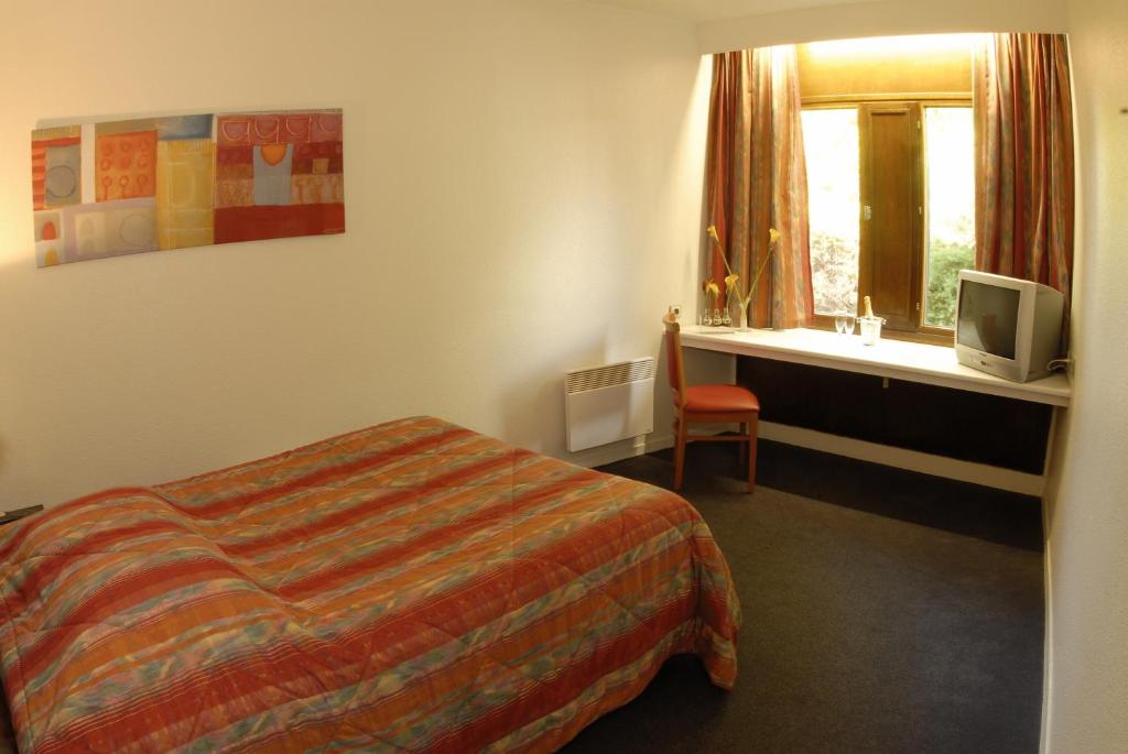 Postel nebo postele na pokoji v ubytování Hôtel Agena