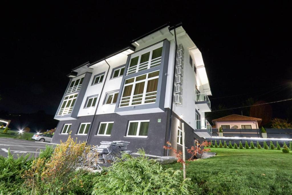 a large white building with windows at night at Villa Panorama in Sarajevo