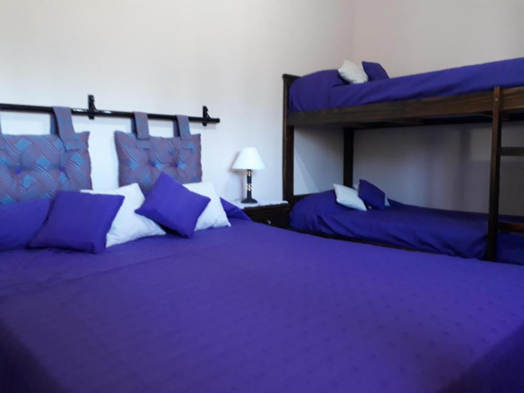 Cabañas Dulce Atardecer tesisinde bir odada yatak veya yataklar