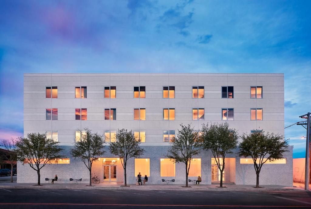 a white building with trees in front of it at Hotel Saint George in Marfa