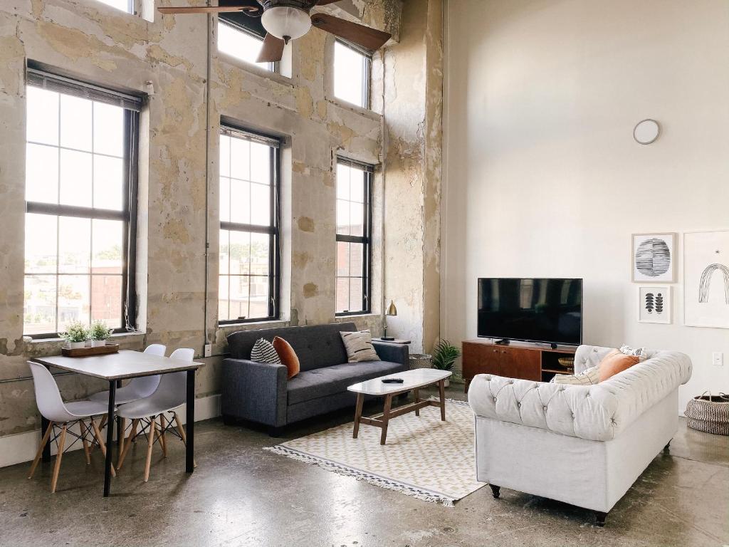 a living room with two couches and a tv at Modern Loft w/ View in Knoxville