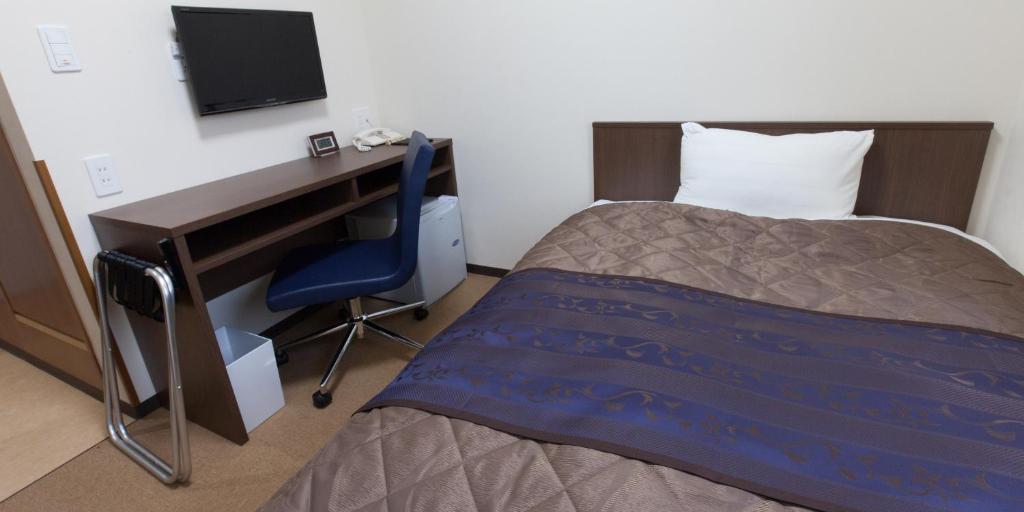 Postel nebo postele na pokoji v ubytování Hotel Wakamatsu Excel