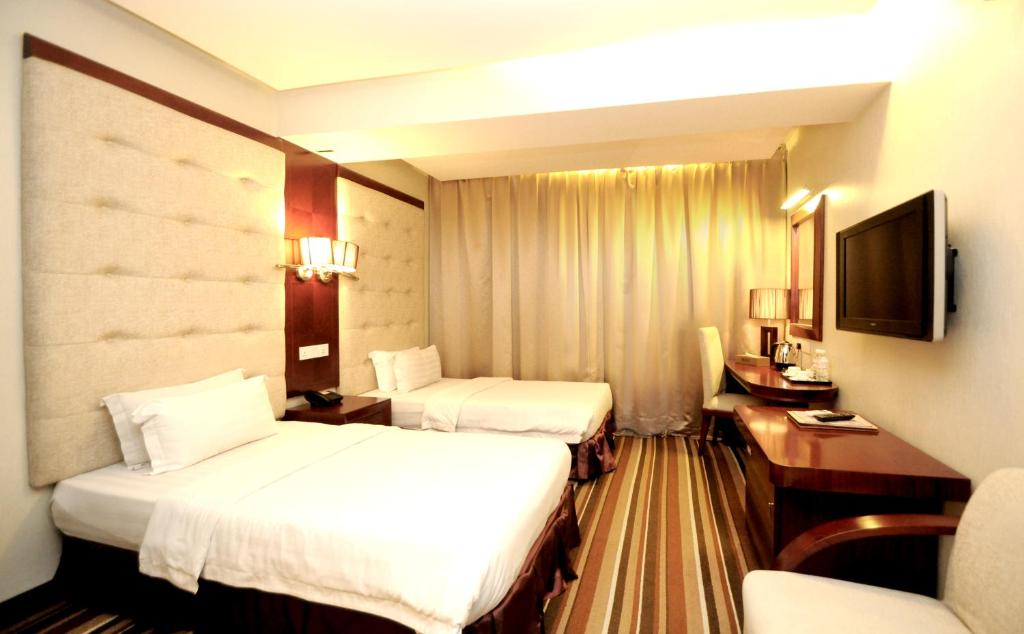 Postel nebo postele na pokoji v ubytování Celyn City Hotel