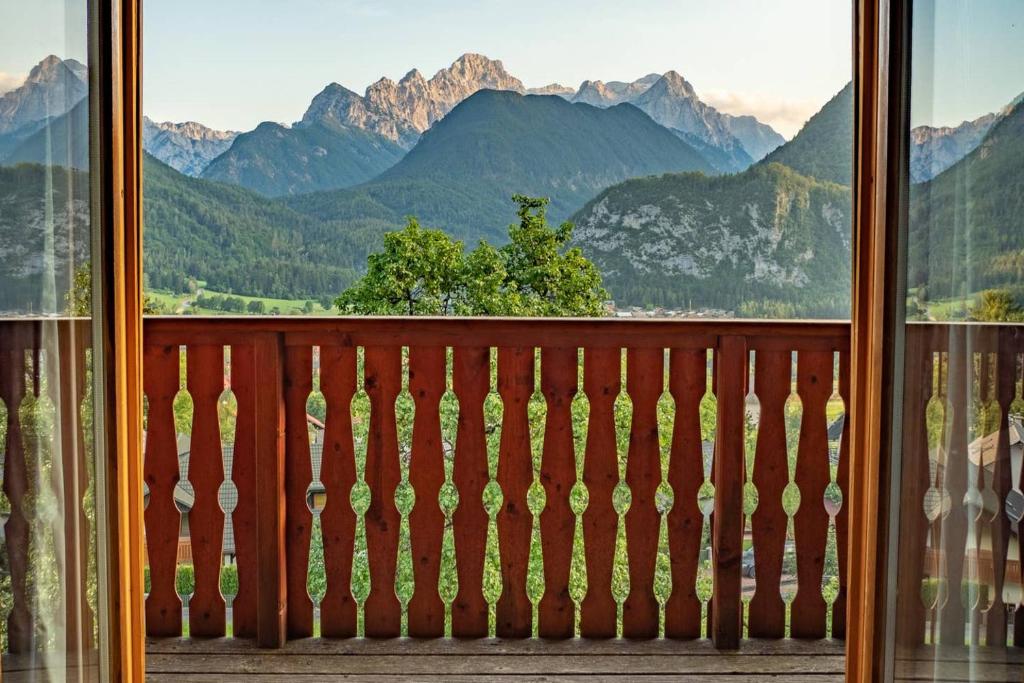 a view from a balcony with a view of mountains at Alpeambient house Dovje in Mojstrana