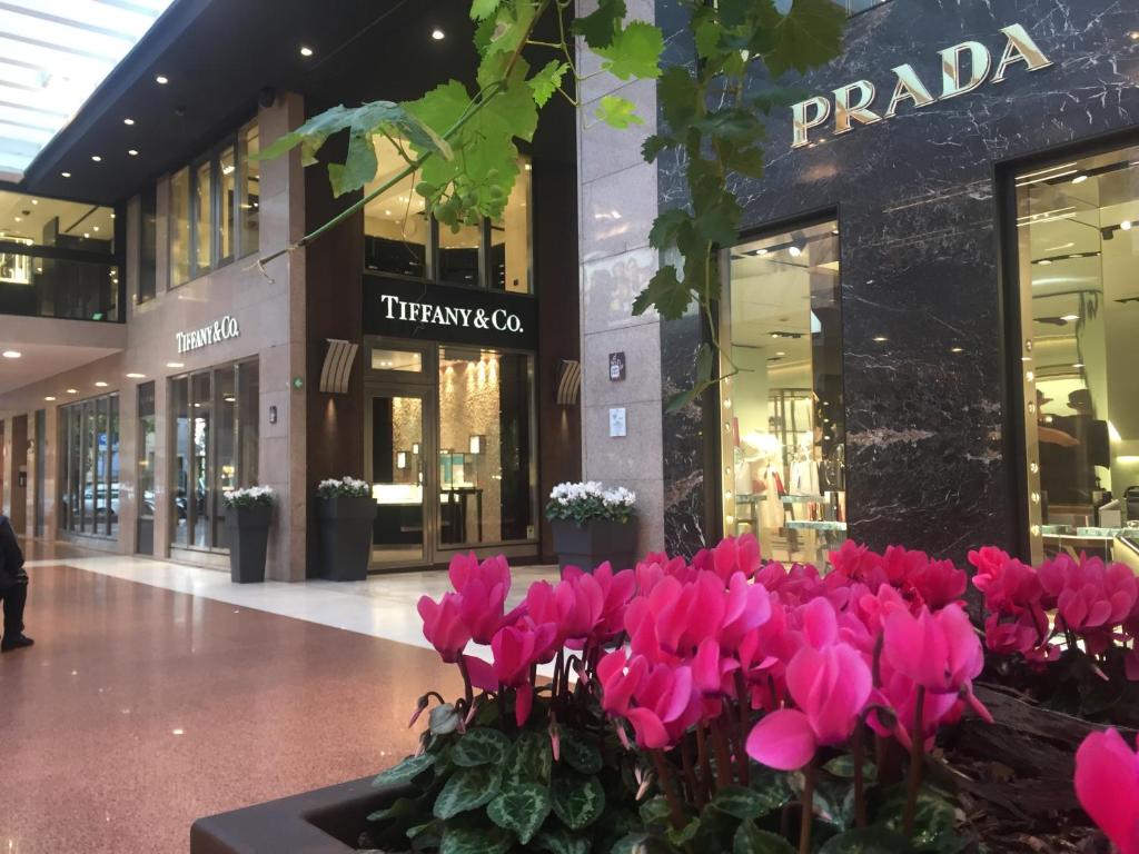 a bunch of pink flowers in front of a shopping mall at B&B Galleria Cavour in Bologna