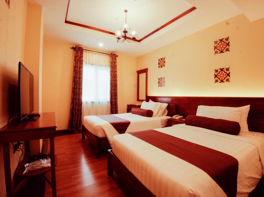 Postel nebo postele na pokoji v ubytování Sunlight Hotel Coron