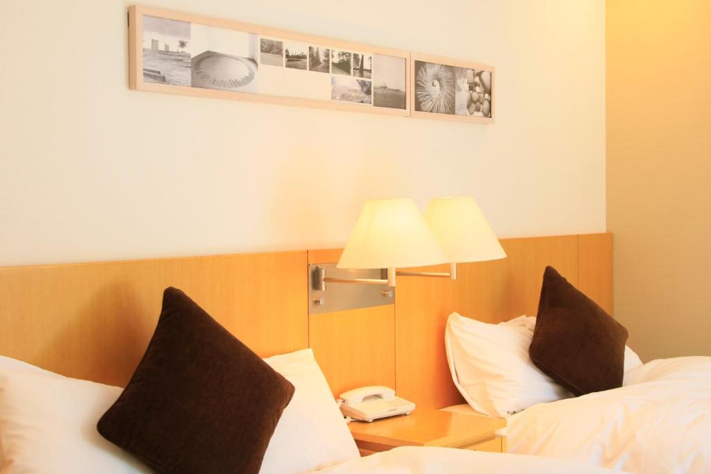 Postel nebo postele na pokoji v ubytování Hotel Shikisai