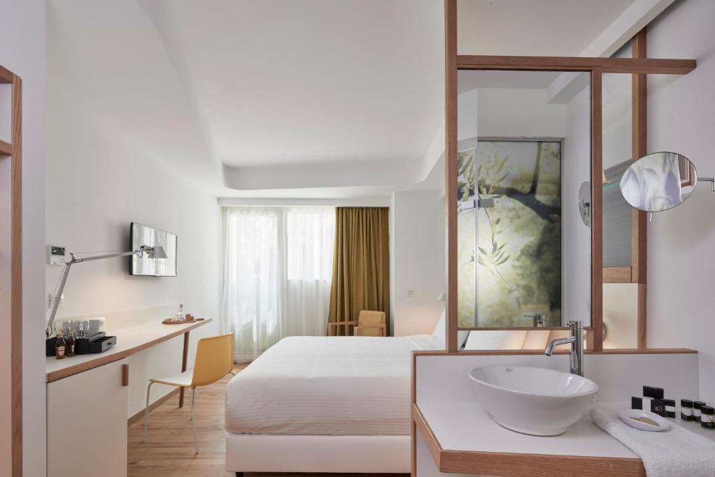 Postel nebo postele na pokoji v ubytování Olive Green Hotel