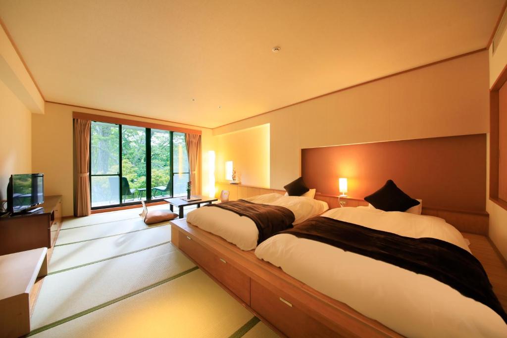 Postel nebo postele na pokoji v ubytování Hotel Shikisai