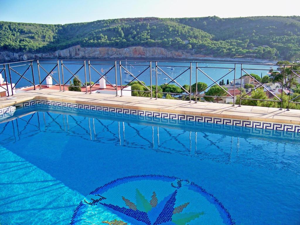 a large swimming pool with a view of the water at Villa Isabelle in L'Escala