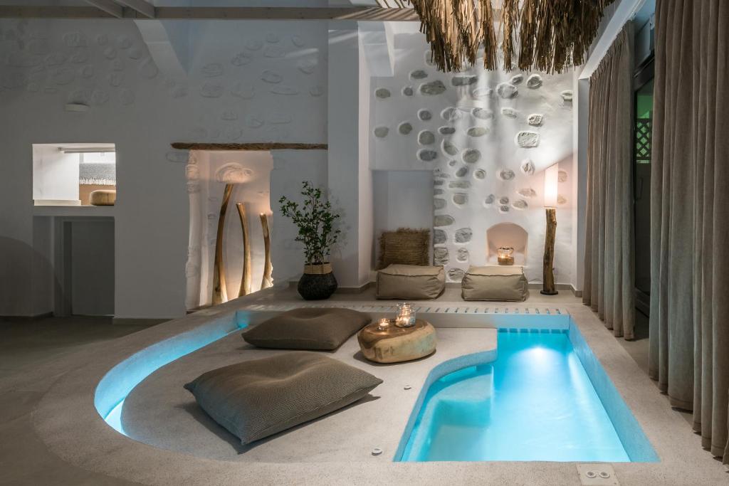 a living room with a pool in the middle of the room at Aphrodite Luxury apartment in Astypalaia