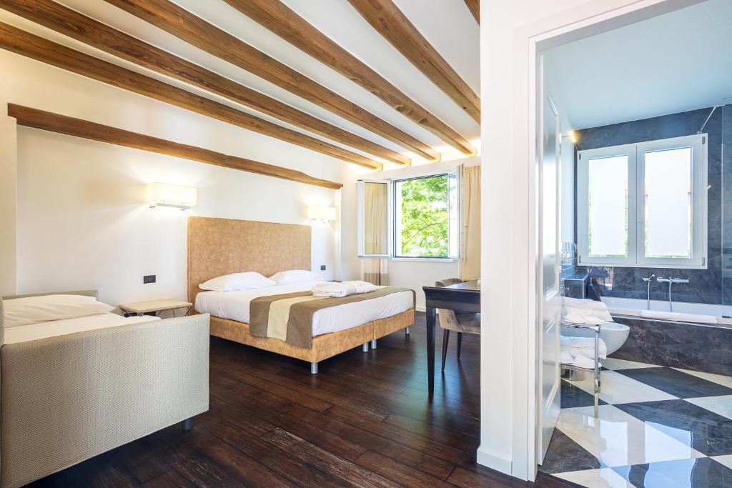 A bed or beds in a room at Raphael Hotel Arbatax