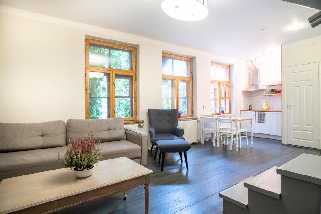 a living room with a couch and a table at Dream Stay - Bright 2-Bedroom 2-Floor Old Town Apartment in Tallinn