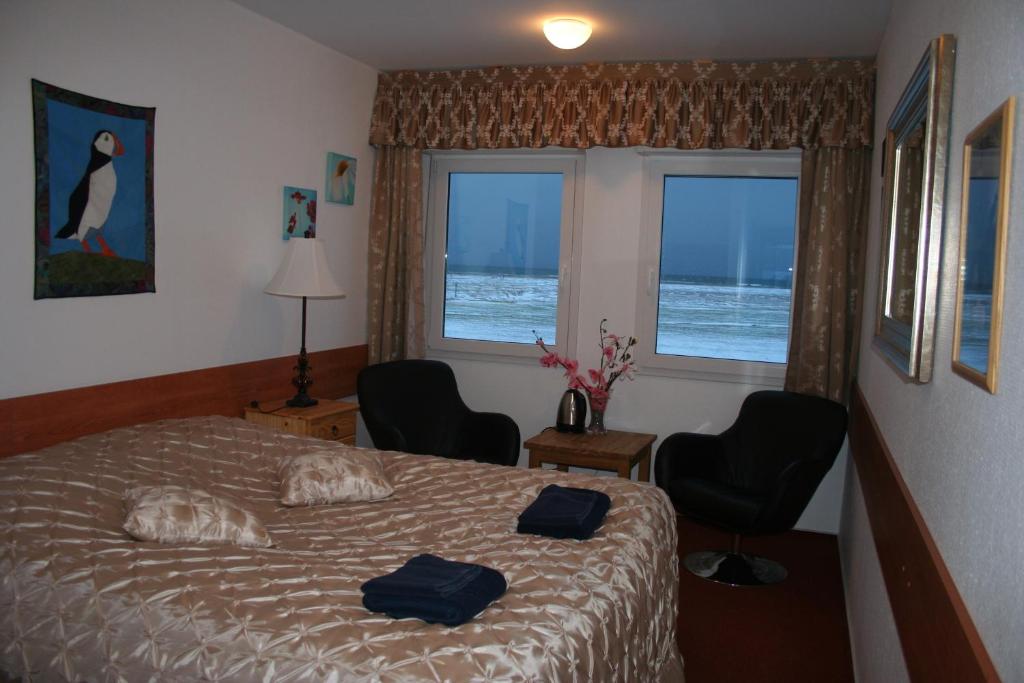 Postel nebo postele na pokoji v ubytování Hotel Breidavik