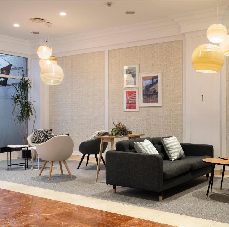 a living room with a couch and a table at Santiago Apartments Bilbao in Bilbao