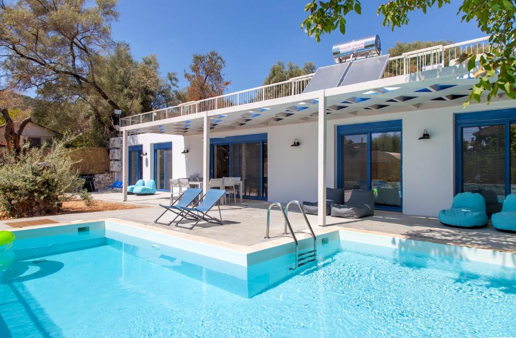 a villa with a swimming pool and a house at Galini Villas in Mikros Gialos