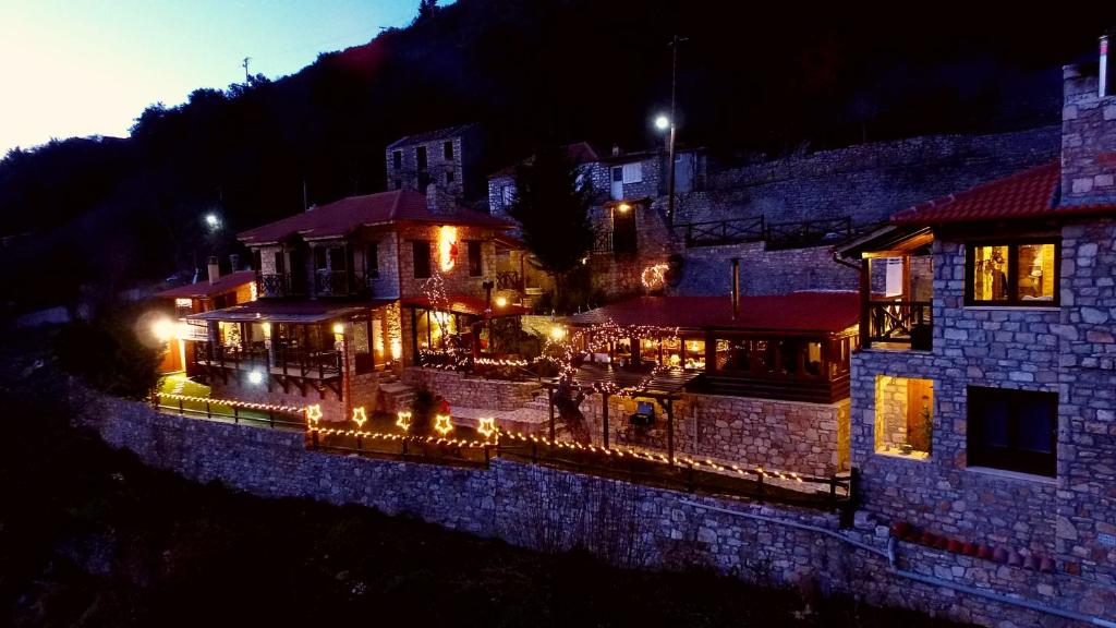 a building with lights in front of it at night at Μαγεμένο Βουνό in Karpenisi