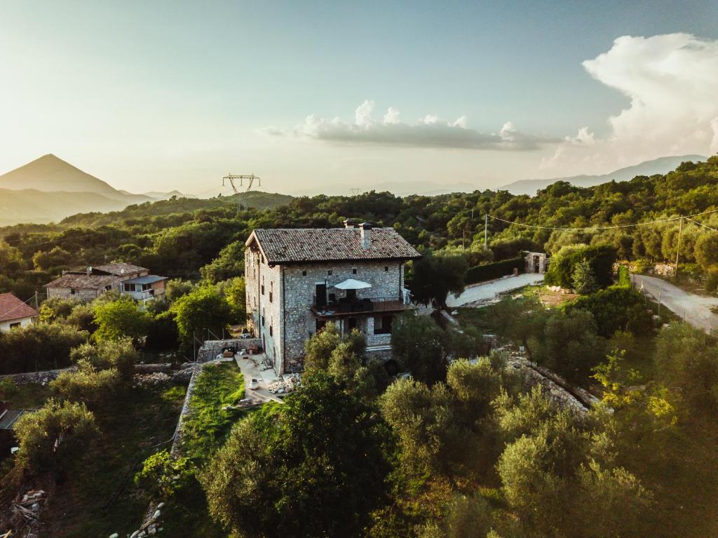 an old stone building on a hill with trees at come prima in Ausonia