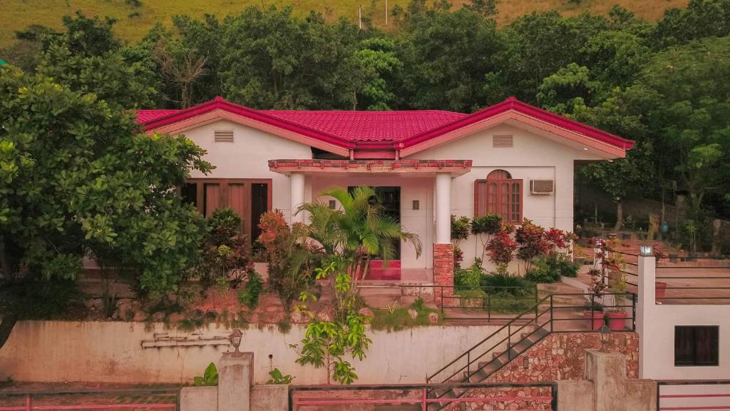 ein kleines weißes Haus mit rotem Dach in der Unterkunft NVH Coron Palawan in Coron