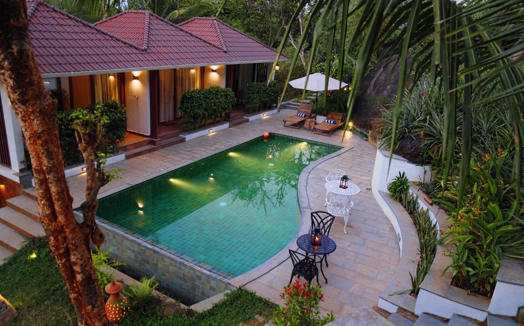 an overhead view of a swimming pool in a house at Le Candles Resort in Kozhikode