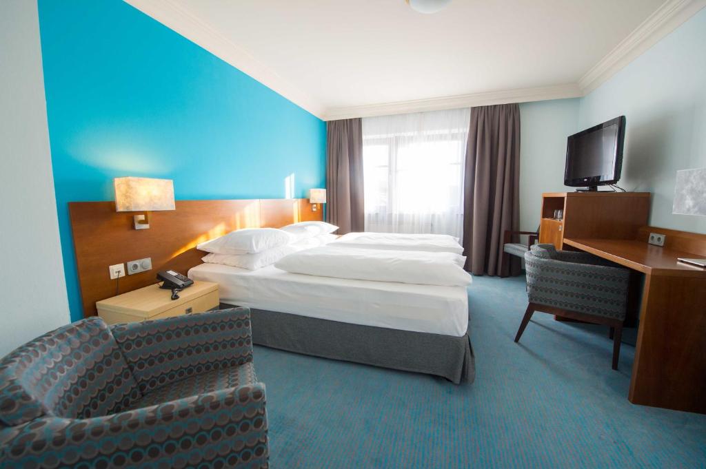 Ein Bett oder Betten in einem Zimmer der Unterkunft Prinzhotel Rothenburg