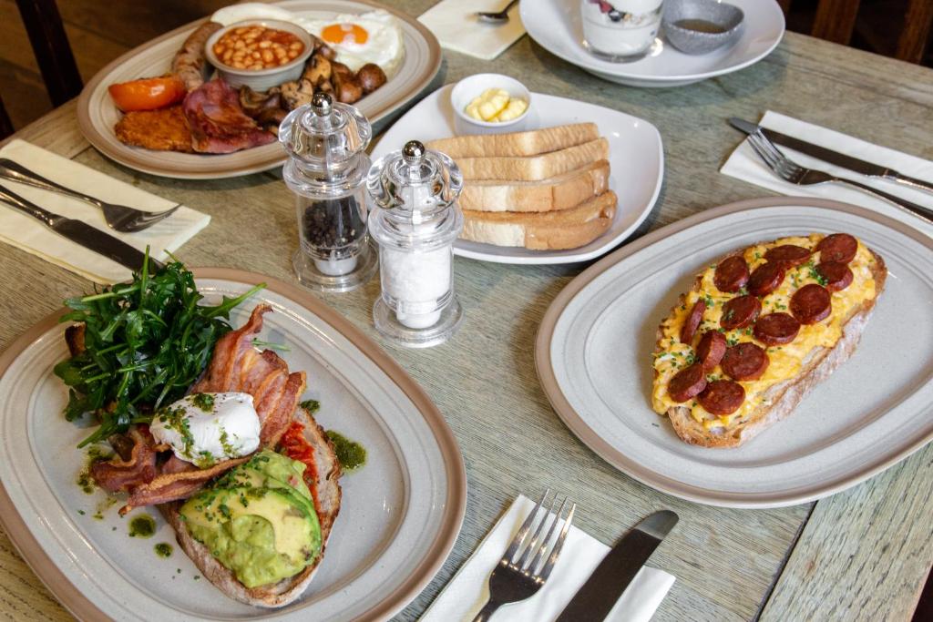 a table with plates of breakfast food on it at The Marine in Whitstable