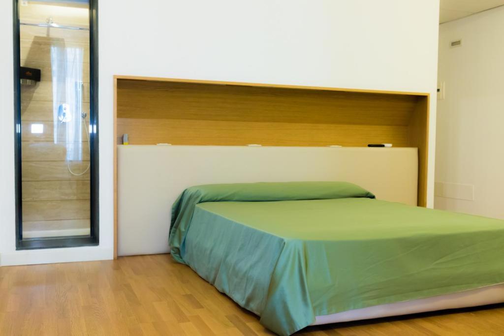 A bed or beds in a room at Nerello Suites and Rooms
