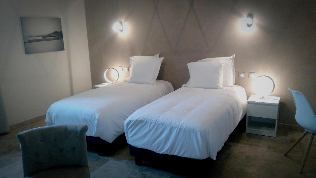 Postel nebo postele na pokoji v ubytování L'hôtel du Couvent