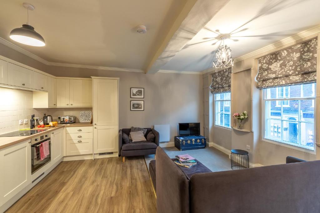 a kitchen and living room with a couch and a table at Apt 3, 71 Micklegate, YORK in York