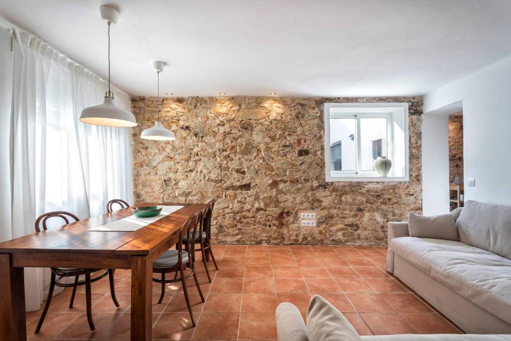 a living room with a table and a couch at Can Terrats in Blanes
