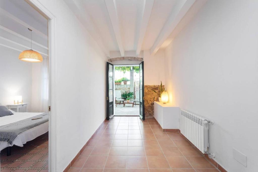 a hallway leading to a bedroom with a bed at Can Terrats in Blanes