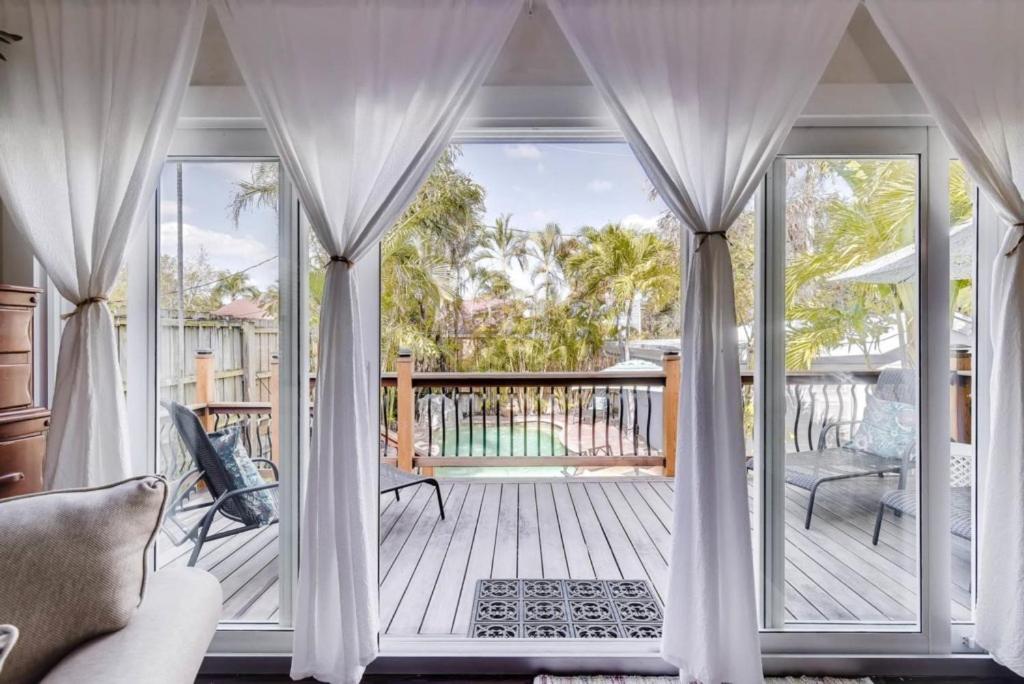 a screened in porch with a view of a deck at West Palm Beauty With Private Pool Home in West Palm Beach