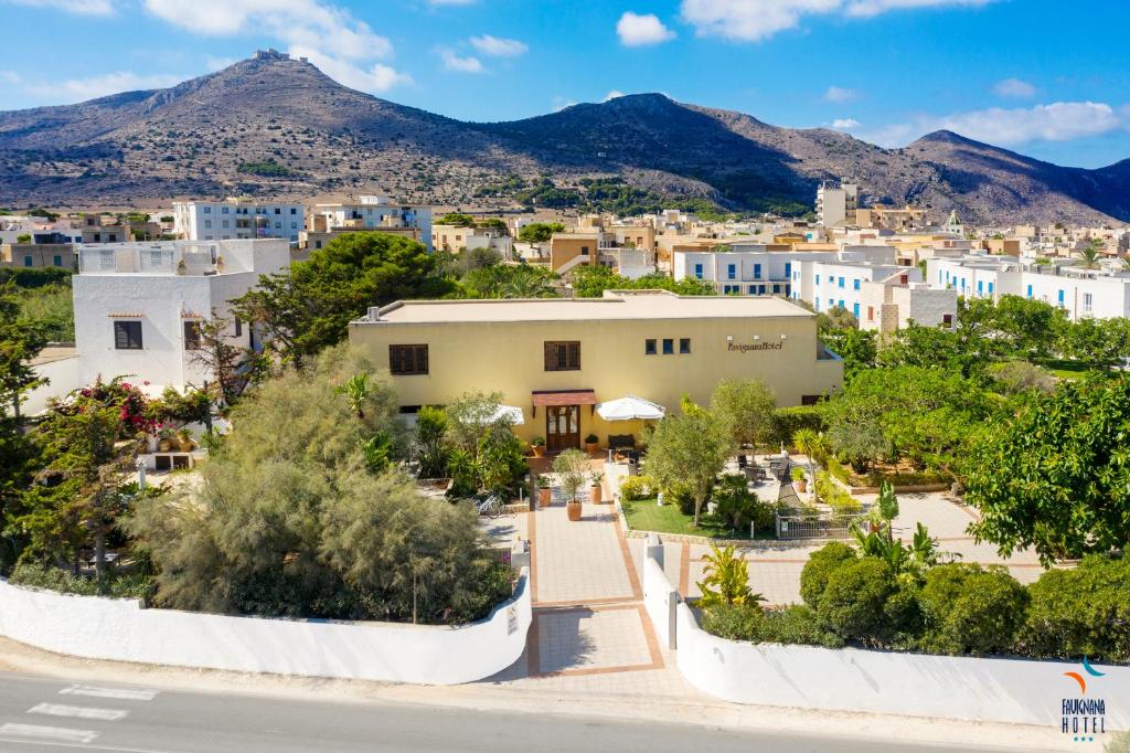 a view of a city with mountains in the background at FAVIGNANA HOTEL Concept Holiday in Favignana