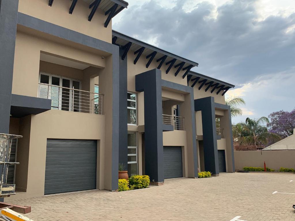 a house with two garage doors in a driveway at 77 On Burger in Polokwane