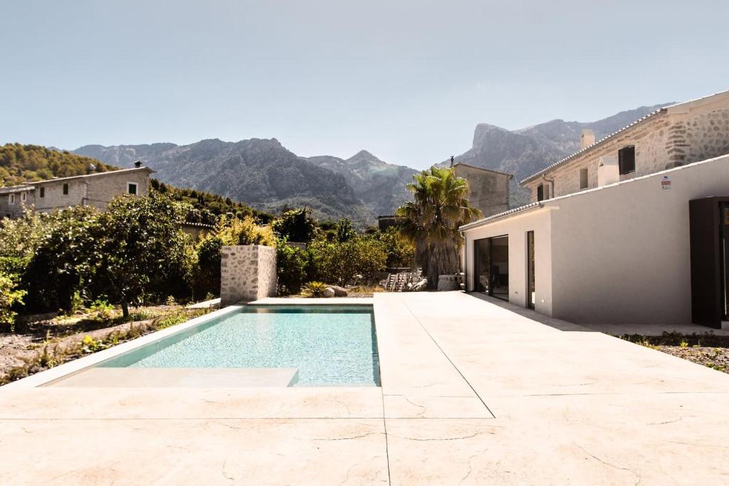 a swimming pool in the backyard of a house at Villa Can Batach-Nueva Construcción en Sóller in Sóller