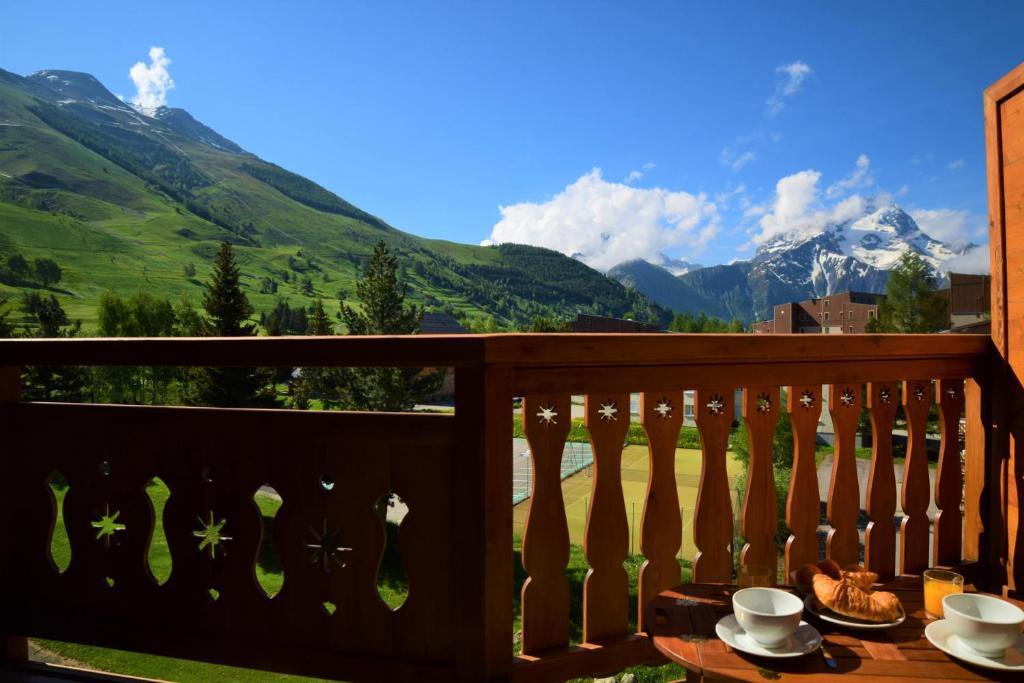 a balcony with a view of the mountains at LE PLEIN SUD in Les Deux Alpes