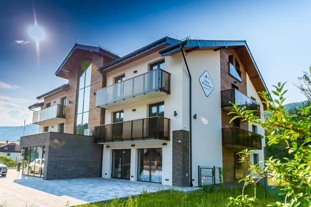 a building with balconies on the side of it at Apartamenty Dolina Skrzycznego in Szczyrk