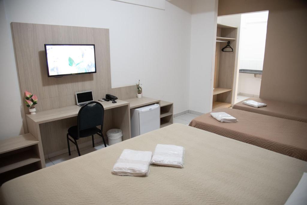 Postel nebo postele na pokoji v ubytování Getúllio Hotel