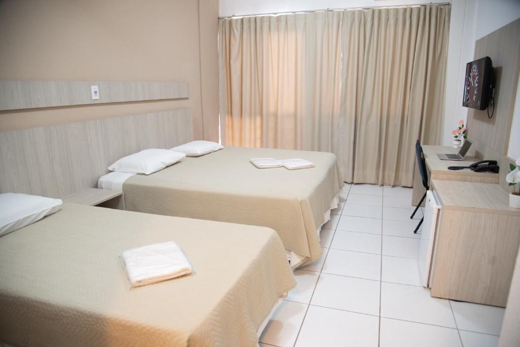 Postel nebo postele na pokoji v ubytování Getúllio Hotel