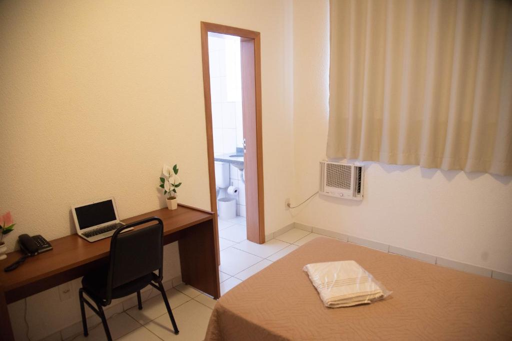 Postel nebo postele na pokoji v ubytování Getúllio Hotel